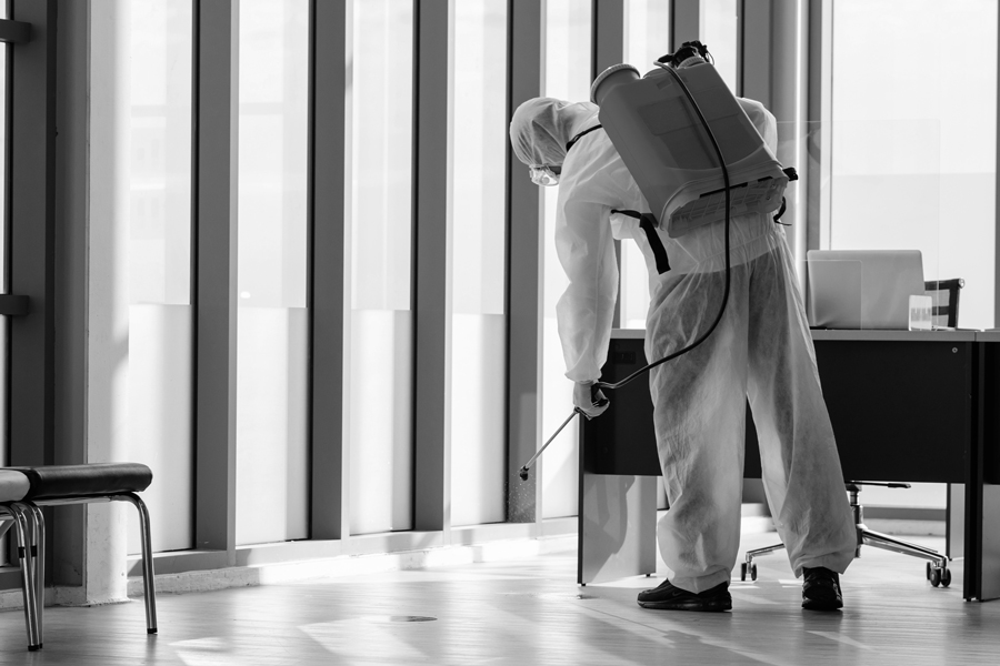 Asbestos abatement worker scraping wall