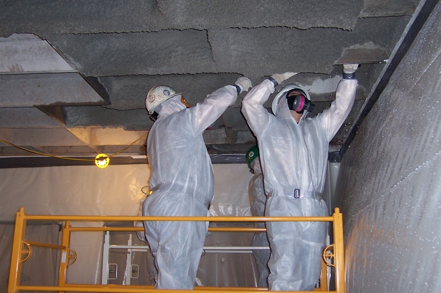Asbestos workers bulk removing asbestos